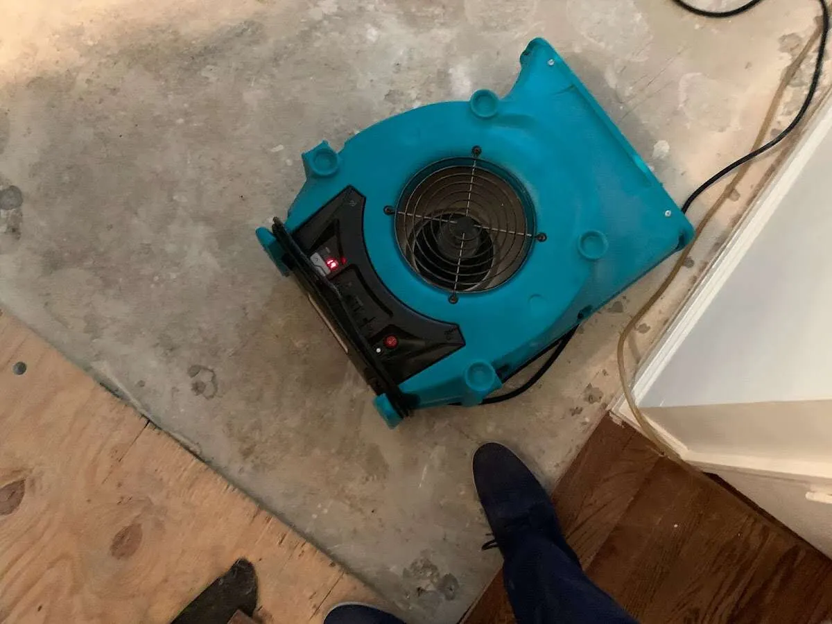 Air mover drying subfloor during Commercial Water Damage Restoration in Lewisville